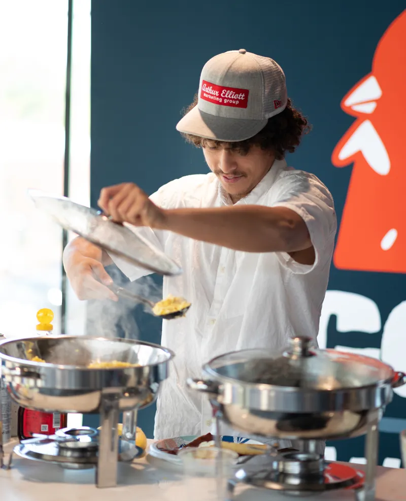 Timmy serving up eggs at Coffles and Waffee