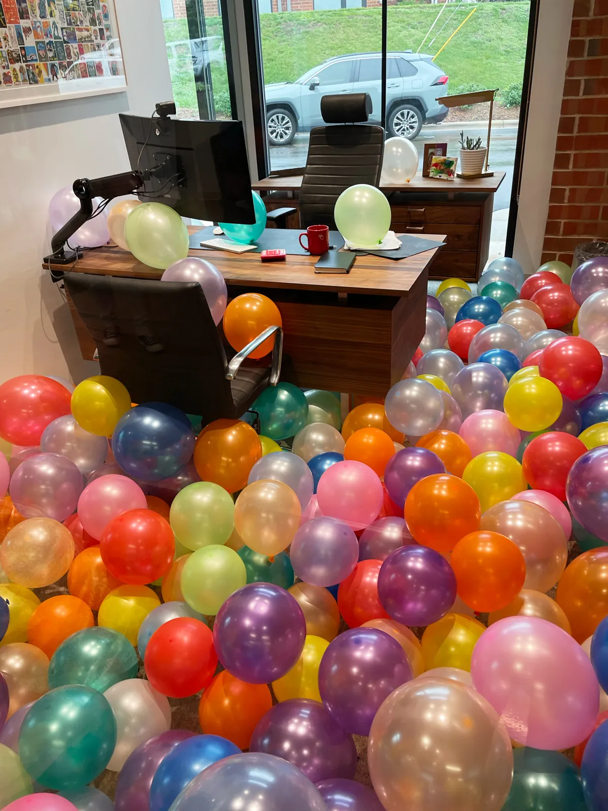 Andy's office filled with balloons on his birthday